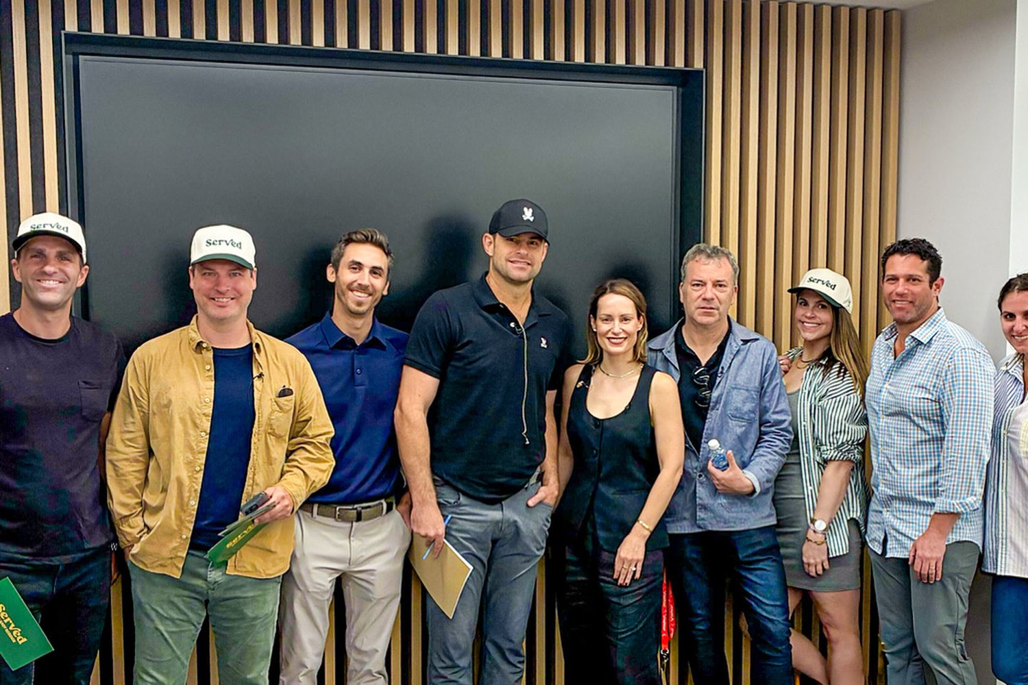 The Served team together after the taping — production crew, the IBM team and Andy Roddick, holding call sheets and Served caps.