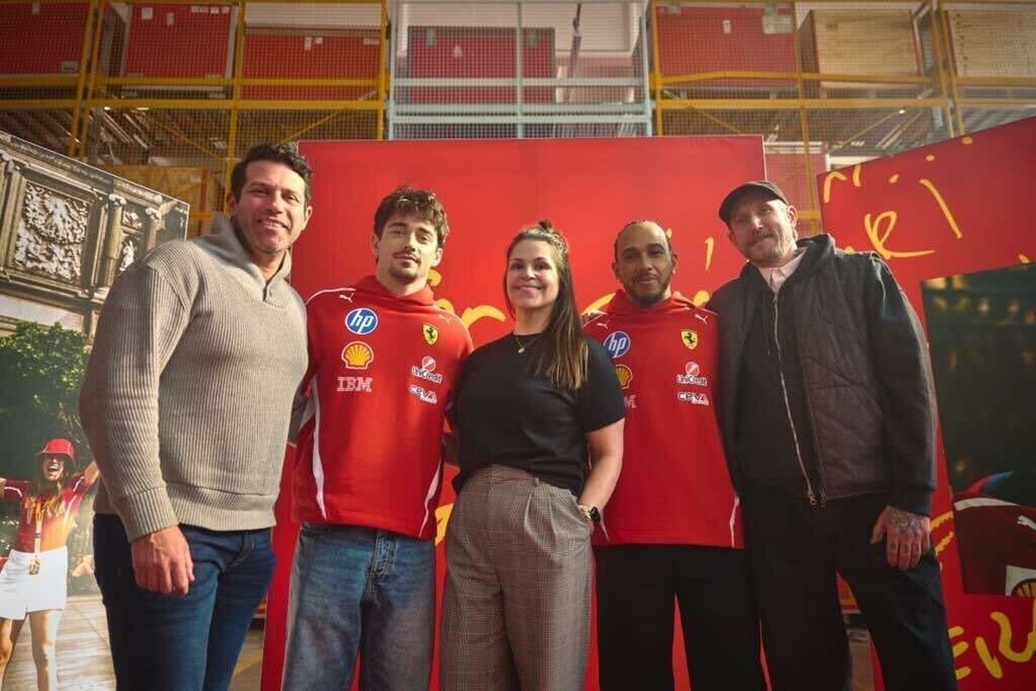 On set at Maranello with the production leads and Ferrari drivers Charles Leclerc and Lewis Hamilton in team kit, in front of the shoot backdrop.